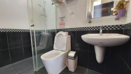 a bathroom with a toilet and a sink at ChaoPingJia Fengge Guesthouse in Wujie