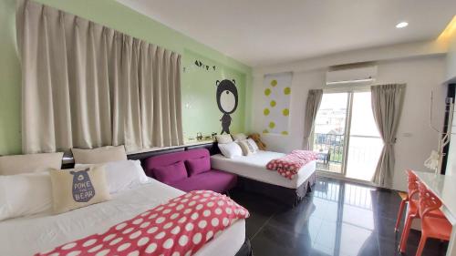 a bedroom with two beds and a purple couch at ChaoPingJia Fengge Guesthouse in Wujie