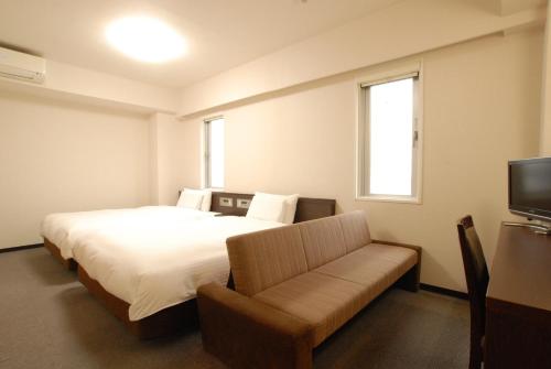 Ліжко або ліжка в номері AB Hotel Toyota Motomachi