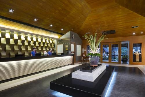 a lobby of a hotel with a reception counter at Novotel Rayong Rim Pae Resort in Klaeng