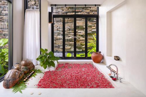 a pile of red petals sitting on a kitchen counter next to a window at Novotel Rayong Rim Pae Resort in Klaeng