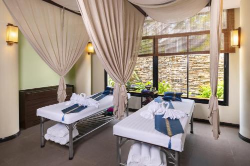 港生Novotel Rayong Rim Pae Resort的有两张床和一扇窗户的房间