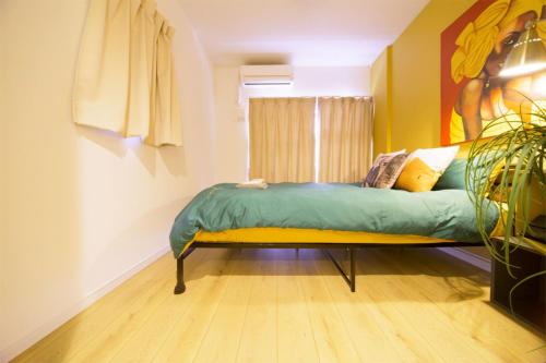 a bed in a room with a window at nestay inn tokyo kagurazaka in Tokyo