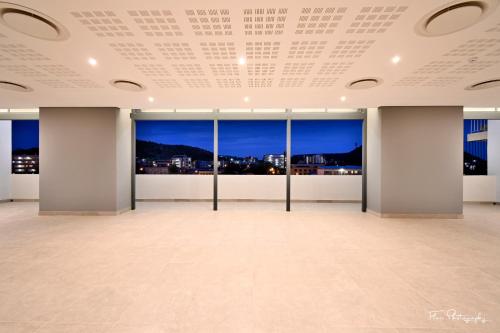 a large room with windows with a view of the city at Premier Splendid Inn Bloemfontein in Bloemfontein
