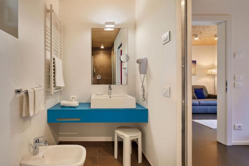 a bathroom with a blue counter and a sink at Alpin Relais B&B Villa Melisse in Colfosco
