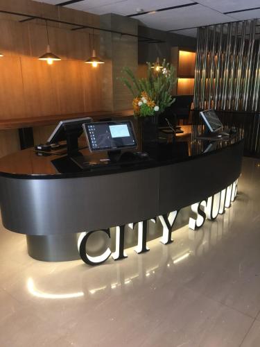 a lobby with a desk with two computers on it at City Suites - Beimen in Taipei