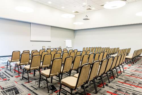 a room with rows of chairs in a classroom at VICTORIA Hotel Kaunas in Kaunas