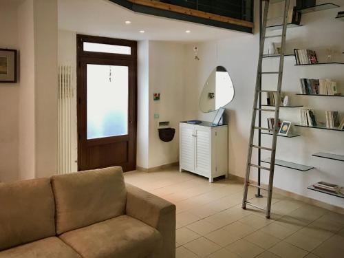 a living room with a couch and a ladder at LOFT 51 in Pescara