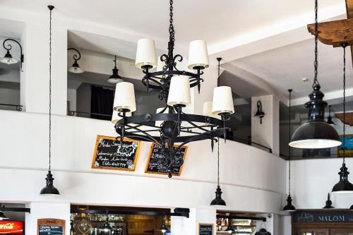 a chandelier hanging from the ceiling of a store at Malom Hotel in Debrecen