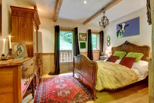 a bedroom with a large bed and a window at La Ferme du Lac Vert in Montriond