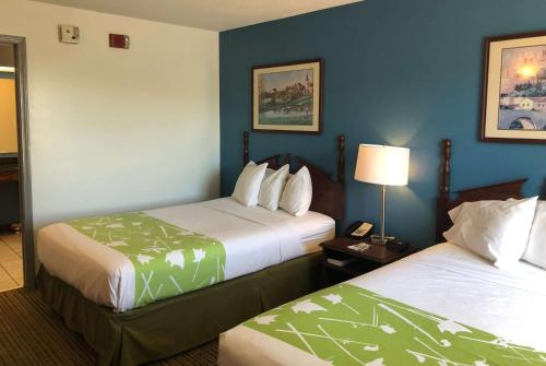 A bed or beds in a room at Baymont by Wyndham Roanoke Rapids
