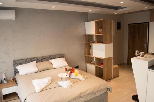 a bedroom with a bed and a sink in a room at DIV APARTMAN in Kragujevac