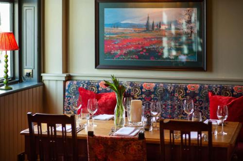 a dining room with a table with wine glasses at The Carnarvon Arms in Newbury