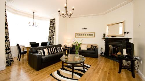 a living room with a black couch and a fireplace at Dublin Vacation Rentals in Dublin
