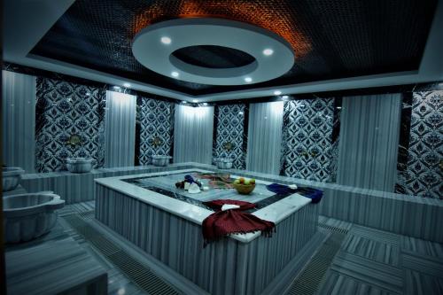 a bathroom with a tub and a sink at Sirena Apart & SPA in Antalya