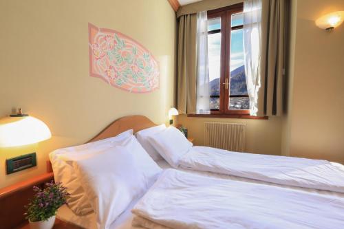 Łóżko lub łóżka w pokoju w obiekcie Palace Pontedilegno Resort