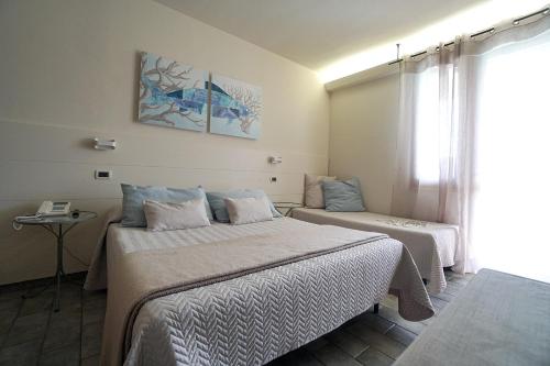 Postel nebo postele na pokoji v ubytování Hotel Residence La Ventola