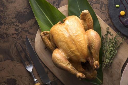 a chicken on a green plate on a table at Sheraton Okinawa Sunmarina Resort in Onna