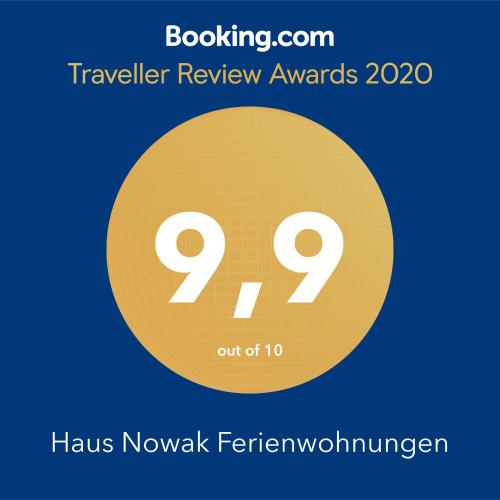a yellow circle with the words haus nowalk ferromyromyherence at Haus Nowak Ferienwohnungen in Millstatt
