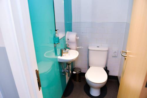a white toilet sitting next to a white sink at YHA London St Pancras in London
