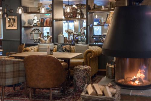 a dining room with a table and a fireplace at The Bridge Hotel in Chertsey