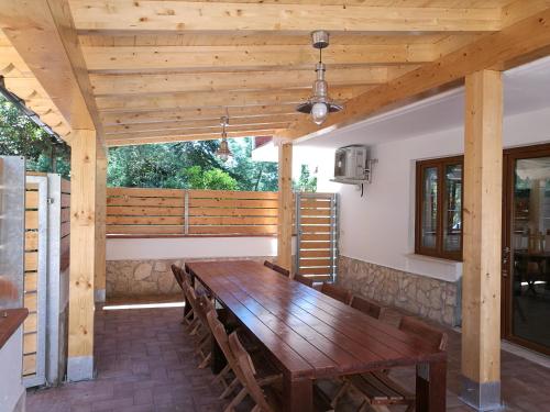 a wooden table and chairs on a patio at Edvige'S House in San Felice Circeo