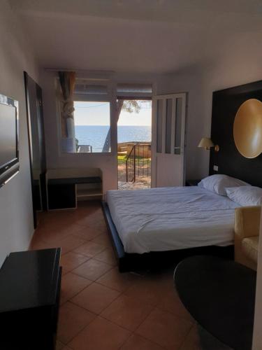 a bedroom with a bed and a view of the ocean at Family Bungalow Pineta in Novigrad Istria