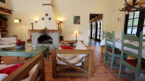 a living room with a fireplace and a table and chairs at Romantic-HuntingLodge-en-Provence**** in Saint-Pierre