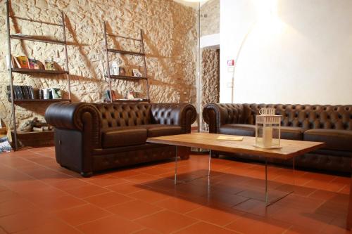 a waiting room with two leather couches and a table at Monastero Di Sant'Erasmo in Veroli
