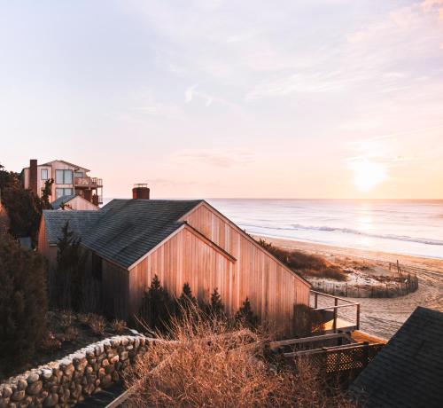 a barn on the beach at sunset at Gurney's Montauk Resort & Seawater Spa in Montauk