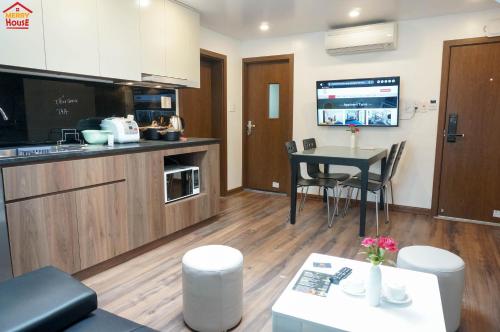 a kitchen with a table and a dining room at Merry House Imperia in Hai Phong