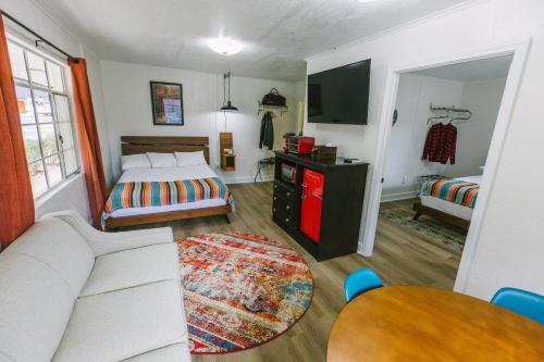 a bedroom with a bed and a couch and a table at Route 19 Inn in Maggie Valley