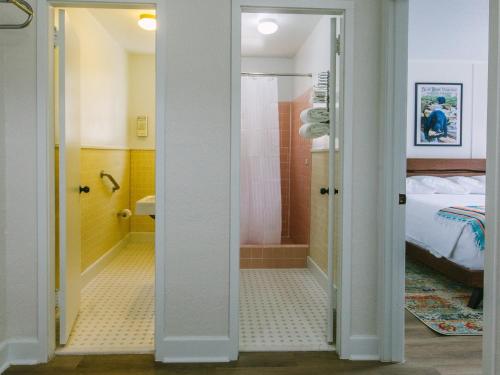 a room with a bathroom with a bed and a shower at Route 19 Inn in Maggie Valley