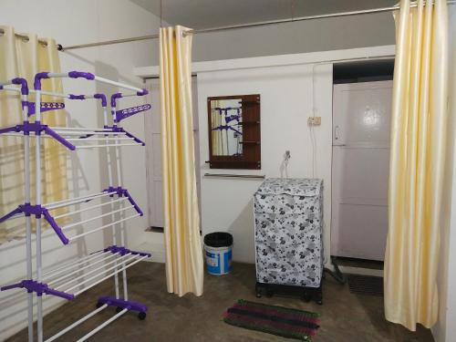 a room with purple bunk beds and yellow curtains at Mayurapriya Inn in Chennai