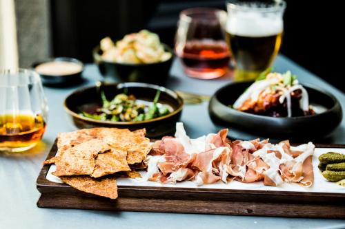 a table with a plate of food and some drinks at Kimpton Hotel Monaco Washington DC by IHG in Washington