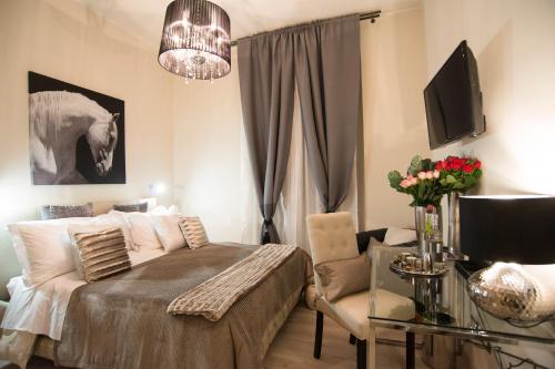 una camera con letto, sedia e televisore di Town House 62 a Roma