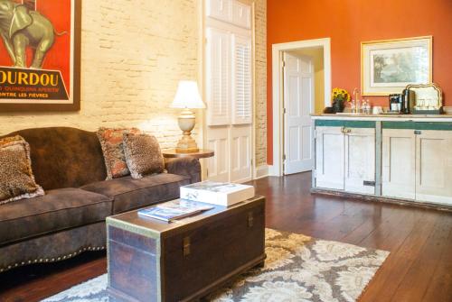 a living room with a couch and a table at Audubon Cottages in New Orleans
