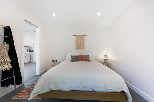 a white bedroom with a large bed in it at Surfer's Paradise in Bodega Bay