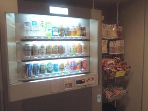 a vending machine filled with lots of drinks and snacks at City Inn Nishi Tanabe / Vacation STAY 78535 in Osaka