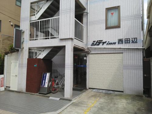 大阪市にあるCity Inn Nishi Tanabe / Vacation STAY 78538の自転車が前に停まった建物