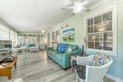 a living room with a blue couch and chairs at Beach Cottage on Jones in Tybee Island