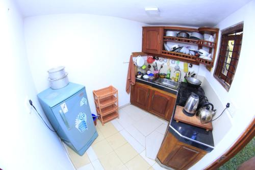 an overhead view of a kitchen with a blue refrigerator at Sunnyplace Guest Mirissa in Mirissa