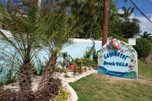 a birthday cake in a yard with a palm tree at Edgewater Beach Villa - Beach Front, Close to All Attractions in St Mary