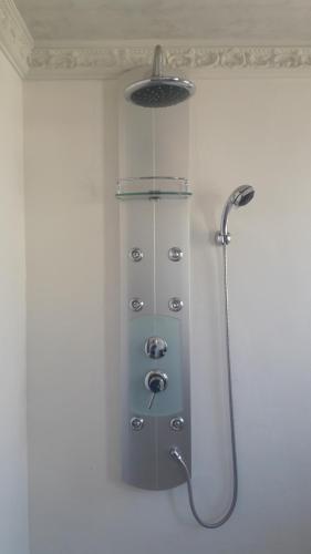 a shower with a shower head in a bathroom at NEW LODGE - Universitas in Bloemfontein