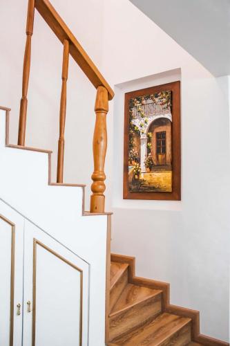 a painting on the wall next to a stairway at Adamas House Hotel Boutique in Quito