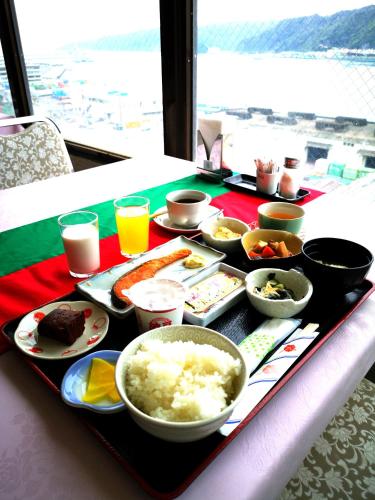 a tray of food on a table with food at Amami Port Tower Hotel in Amami