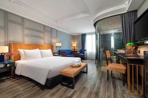 a hotel room with a bed and a desk at Solaria Hanoi Hotel in Hanoi