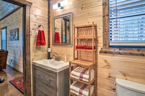 a bathroom with a sink and a toilet at The Breeze Forested Oasis with Hot Tub and Deck! in Broken Bow