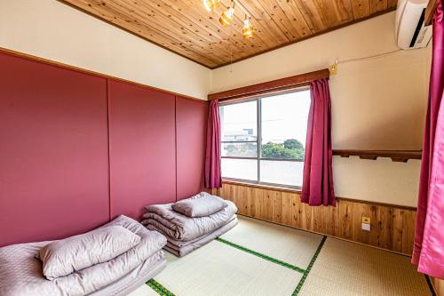 a room with two bean bags and a window at 47HOSTEL in Wadomari