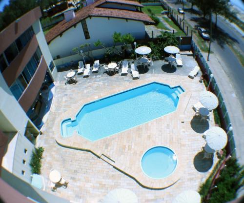 an overhead view of a swimming pool at a resort at De Rose Praia Hotel in Torres